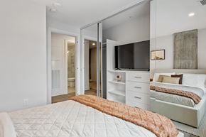 Ottawa apartment for rent - A bedroom with a bed, dresser, and mirror.