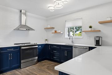 Canton apartment for rent - A modern kitchen with dark blue cabinets and stainless steel appliances.