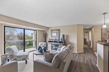 Kentwood apartment for rent - A living room with a grey couch and a chair with a blue patterned cushion.