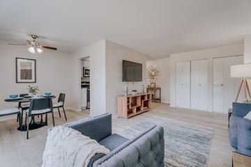 Troy apartment for rent - A living room with a grey couch and a wooden coffee table.