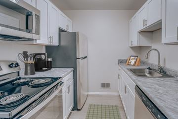 Southfield apartment for rent - A kitchen with a blue stove top and white cabinets.
