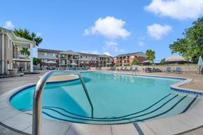 Waterford Twp apartment for rent - A large swimming pool in front of apartment buildings.