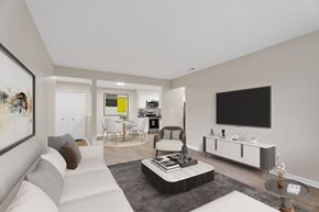 Waterford Twp apartment for rent - A modern living room with a white sofa, a black TV, and a grey rug.