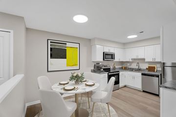 Waterford Twp apartment for rent - A modern kitchen with a dining table set for two.