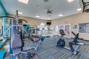 Sterling Heights apartment for rent - A gym with a variety of equipment including treadmills, stationary bikes, weights, and exercise machines.