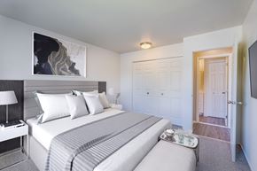 Sterling Heights apartment for rent - A bedroom with a large bed and a painting on the wall.