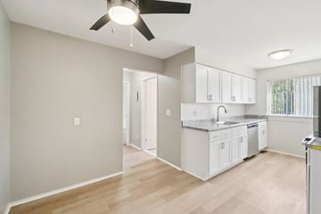 Woodhaven apartment for rent - A kitchen with white cabinets and a ceiling fan.