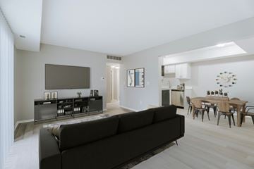 Ann Arbor apartment for rent - A living room with a black couch and a television.