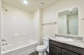 Magna apartment for rent - A white bathroom with a toilet, sink, and bathtub.