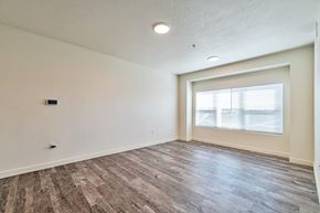 Magna apartment for rent - A room with a window and wooden flooring.
