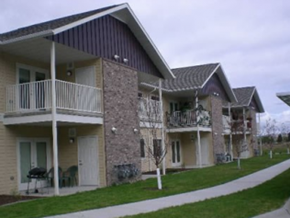 Butte apartment for rent - an apartment building with two balconies and a sidewalk