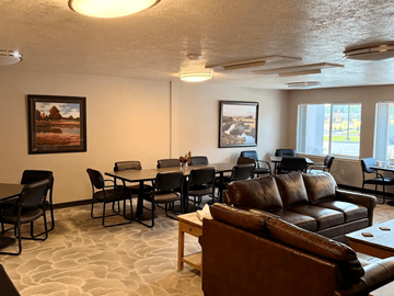 Eagle apartment for rent - A living room with a couch, chairs, and two pictures on the wall.