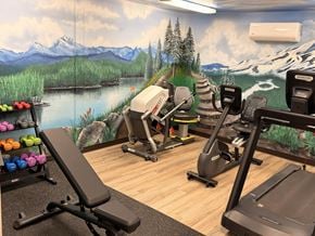 Eagle apartment for rent - A gym with a mountain mural on the wall.