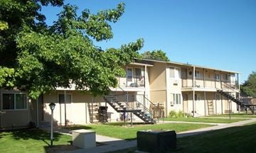 Ontario apartment for rent - Apartment complex with green trees in front.