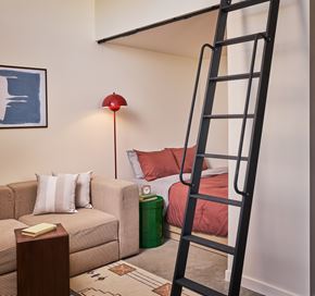 Detroit apartment for rent - A black ladder is leaning against a wall in a living room.