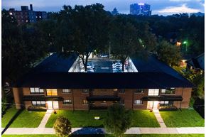Detroit apartment for rent - A large building with a pool in the middle of it.