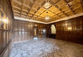 Detroit apartment for rent - A large room with wooden walls and a marble floor.