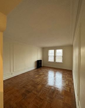 Detroit apartment for rent - A room with wooden floors and a window.