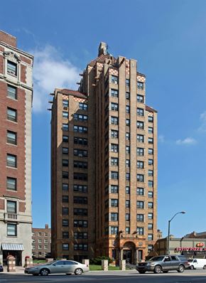 Detroit apartment for rent - A tall brick building with a red brick building to the left of it.