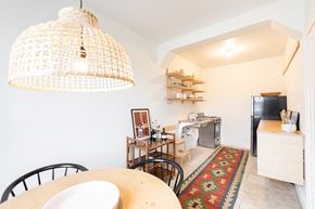 Detroit apartment for rent - A kitchen with a table and chairs under a hanging light fixture.
