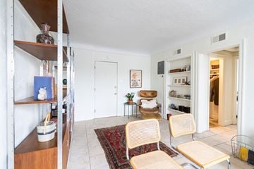 Detroit apartment for rent - A living room with a rug, two chairs and a table.