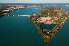 Detroit apartment for rent - A bridge spans a body of water, connecting two land masses.