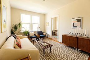 Detroit apartment for rent - A living room with a sofa, chairs, and a rug.