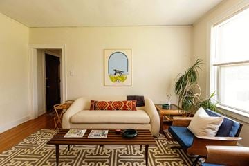 Detroit apartment for rent - A living room with a white couch and a painting on the wall.