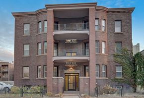 Detroit apartment for rent - A red brick building with a balcony on the second floor.