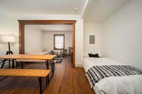 Detroit apartment for rent - A bedroom with a bed, a desk, and a chair.