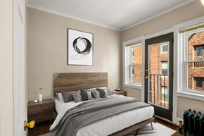 Detroit apartment for rent - A bedroom with a large bed and a picture on the wall.