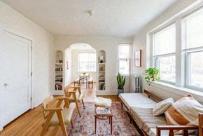 Detroit apartment for rent - A living room with a sofa, chairs, and a rug.