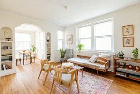 Detroit apartment for rent - A living room with a sofa, a table, and a bookshelf.