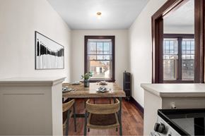 Detroit apartment for rent - A dining room with a wooden table and chairs.