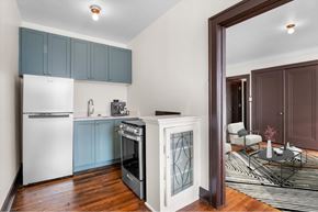 Detroit apartment for rent - A kitchen with a white refrigerator and a stainless steel oven.