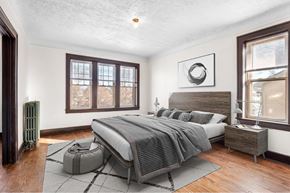Detroit apartment for rent - A bedroom with a large bed and a window.