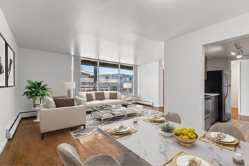 Detroit apartment for rent - A modern living room with a dining table set for two.