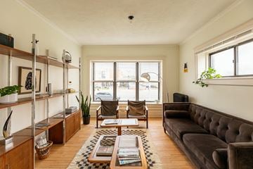 Detroit apartment for rent - A living room with a brown couch and a coffee table.