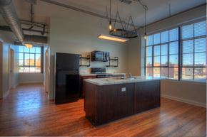 Union City apartment for rent - an empty kitchen with a large island and a large window