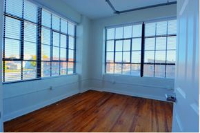 Union City apartment for rent - an empty room with wooden floors and large windows