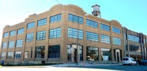Union City apartment for rent - a large brick building with large windows and a water tower