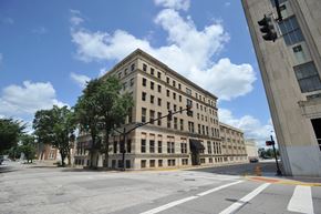 Evansville apartment for rent - a large building on the corner of an empty street