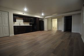 Evansville apartment for rent - an empty living room with wooden floors and a kitchen