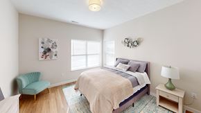 Indianapolis apartment for rent - Bedroom with a bed and a chair and a window  at The Landing Apartments, Indiana