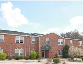 Ligonier apartment for rent - the front of a brick building with a green awning