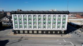 Crawfordsville apartment for rent - A large white building with green trim and a black roof.