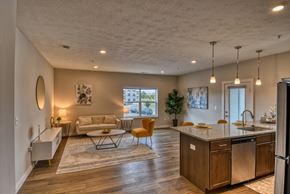 Indianapolis apartment for rent - A modern kitchen with a dining table and chairs at The Landing Apartments, Indianapolis
