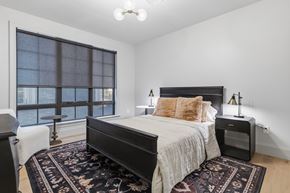 Philadelphia apartment for rent - A bedroom with a large bed and a window overlooking the water.