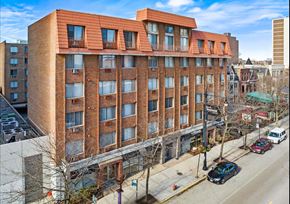 Chicago apartment for rent - A red brick building with a balcony on the top floor.