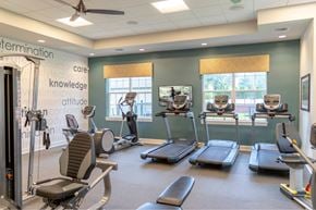Cinnaminson apartment for rent - A gym with treadmills, weights, and exercise equipment.